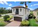 Charming two-story home with a barrel tile roof, balcony, brick driveway, and attached two-car garage at 970 Golden Bear Dr, Reunion, FL 34747