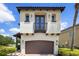 Stately two-story home with a balcony, stucco finish and a two car garage at 970 Golden Bear Dr, Reunion, FL 34747