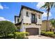 Charming two-story home with a private balcony and beautiful landscaping at 970 Golden Bear Dr, Reunion, FL 34747