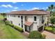 Stunning two-story home with a tile roof, manicured lawn, and meticulously landscaped yard at 970 Golden Bear Dr, Reunion, FL 34747