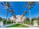 Grand resort entrance framed by tall palm trees and manicured hedges against a clear blue sky at 970 Golden Bear Dr, Reunion, FL 34747
