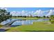 Scenic view of a lush golf course with a bridge over a serene lake and the main resort in the background at 970 Golden Bear Dr, Reunion, FL 34747