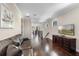 Bright hallway with hardwood floors, recessed lighting, crown molding and leather sofa provides ample space at 970 Golden Bear Dr, Reunion, FL 34747