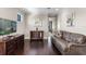 Bright hallway with hardwood floors and leather sofa provides ample space at 970 Golden Bear Dr, Reunion, FL 34747