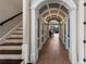 Elegant hallway features arched doorways and tile flooring, leading to the staircase and an open living area at 970 Golden Bear Dr, Reunion, FL 34747