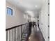 Bright hallway with hardwood floors, recessed lighting, crown molding and iron railing at 970 Golden Bear Dr, Reunion, FL 34747