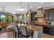 Open-concept kitchen with island seating, granite countertops, and seamless flow to living area at 970 Golden Bear Dr, Reunion, FL 34747