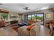 Comfortable living room with a ceiling fan, tile floors, and sliding glass doors to the patio at 970 Golden Bear Dr, Reunion, FL 34747