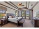 A spacious bedroom includes a patterned ceiling, a bench at the foot of the bed, and large windows at 970 Golden Bear Dr, Reunion, FL 34747