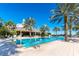 Inviting resort pool with palm trees and the clubhouse in the background, ideal for leisure and recreation at 970 Golden Bear Dr, Reunion, FL 34747