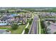 Scenic street view of a luxury neighborhood with beautifully landscaped homes near a golf course and community lakes at 970 Golden Bear Dr, Reunion, FL 34747