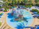 Aerial view of a fun water park with slides, splash pads, and colorful structures, perfect for families at 970 Golden Bear Dr, Reunion, FL 34747
