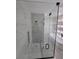 Luxurious bathroom featuring a tiled shower with a glass door and a built-in shower caddy at 1005 Randall St, Orlando, FL 32805