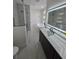 Spacious primary bathroom with double vanity, modern tub, and glass shower at 1005 Randall St, Orlando, FL 32805