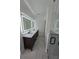 Bright bathroom with a double sink vanity, illuminated mirrors, and a sleek glass shower at 1005 Randall St, Orlando, FL 32805
