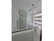 Bright bathroom featuring a glass-enclosed shower, soaking tub, and modern fixtures at 1005 Randall St, Orlando, FL 32805