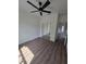 Clean bedroom with wood floors, ceiling fan and mirrored closet at 1005 Randall St, Orlando, FL 32805