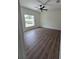 Cozy bedroom with hardwood floors, a modern ceiling fan, and a bright window at 1005 Randall St, Orlando, FL 32805