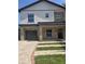Modern two-story home boasts stone accents, black trim, and manicured landscaping for curb appeal at 1005 Randall St, Orlando, FL 32805