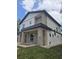 Stylish two-story home showcases modern design with stone veneer and a well-maintained front lawn at 1005 Randall St, Orlando, FL 32805