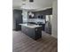 Contemporary kitchen featuring stainless appliances, a stylish island, and modern lighting fixtures at 1005 Randall St, Orlando, FL 32805