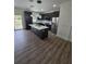 Modern kitchen features an island, stainless steel appliances, and dark cabinetry with bright lighting at 1005 Randall St, Orlando, FL 32805