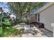 Serene backyard featuring a comfortable outdoor lounge area, patio and lush greenery for relaxation and enjoyment at 10293 Cypress Knee Cir, Orlando, FL 32825
