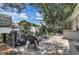 Inviting backyard with a well-maintained patio area, outdoor seating, grill and lush greenery for relaxation at 10293 Cypress Knee Cir, Orlando, FL 32825