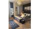 Well-appointed bedroom with stylish decor, a full-length mirror, and a comfortable bed with patterned bedding at 10293 Cypress Knee Cir, Orlando, FL 32825