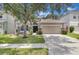Inviting single-Gathering home with lush green lawn, stone accents, and a two-car garage at 10293 Cypress Knee Cir, Orlando, FL 32825