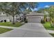 Charming single-Gathering home with a well-maintained lawn, stone accents, and a two-car garage at 10293 Cypress Knee Cir, Orlando, FL 32825