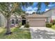 Charming single-Gathering home with a well-maintained lawn, beautiful stone accents, and a two-car garage at 10293 Cypress Knee Cir, Orlando, FL 32825