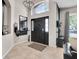 Bright foyer features tile floors, a decorative mirror, and a modern light fixture at 10293 Cypress Knee Cir, Orlando, FL 32825