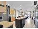 Bright kitchen featuring an island with bar seating, and modern appliances at 10293 Cypress Knee Cir, Orlando, FL 32825