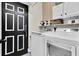 Laundry room featuring a modern washer and dryer and a decorated entry door at 10293 Cypress Knee Cir, Orlando, FL 32825