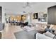 Bright living room adjacent to kitchen featuring a comfortable sofa and neutral decor at 10293 Cypress Knee Cir, Orlando, FL 32825