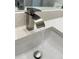 Close up of a modern bathroom faucet and sink with stylish, speckled countertop at 107 Grove St, Orlando, FL 32835