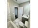 Full bathroom featuring a toilet, vanity, mirror, tile flooring, and combined shower and tub at 107 Grove St, Orlando, FL 32835