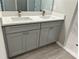 Double sink bathroom vanity with gray cabinets, modern countertops, and wood look flooring at 107 Grove St, Orlando, FL 32835