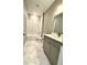 Tastefully designed bathroom with gray cabinets, stylish shower, and marble style flooring at 107 Grove St, Orlando, FL 32835