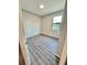 Neutral bedroom with light-colored walls, modern flooring, and a sunny window at 107 Grove St, Orlando, FL 32835