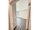 Bright bedroom with wood-look flooring, neutral walls, and natural light at 107 Grove St, Orlando, FL 32835