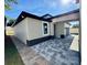 Side view of home with paver driveway and a stone accent wall, showcasing exterior architecture at 107 Grove St, Orlando, FL 32835