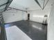 Spacious two-car garage featuring a sealed floor, ample lighting, and a modern garage door at 107 Grove St, Orlando, FL 32835