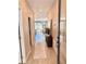 Long hallway showcasing wood-look tile, leading to an open floor plan, and natural light enhancing the space at 107 Grove St, Orlando, FL 32835