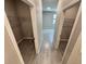 Hallway with two walk-in closets and tile floors at 107 Grove St, Orlando, FL 32835