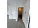 Hallway showcasing modern tile flooring, neutral paint, and staircase at 107 Grove St, Orlando, FL 32835