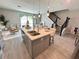 Modern kitchen island featuring stainless steel sink, seating, and stylish pendant lighting enhancing the open layout at 107 Grove St, Orlando, FL 32835