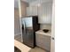 Bright kitchen boasts stainless steel refrigerator and gray cabinets at 107 Grove St, Orlando, FL 32835
