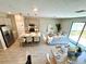 Open-concept living space with kitchen island, stainless steel appliances, and stylish seating at the counter at 107 Grove St, Orlando, FL 32835